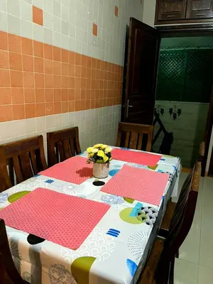 a table with red and white table cloths on it at Appartement meublé Centre de Témara in Temara