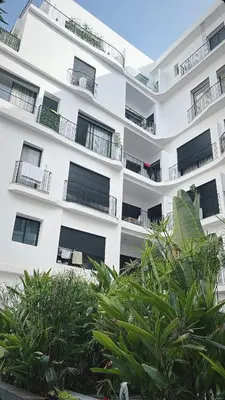 a white apartment building with balconies and plants at Adam résidence in Casablanca