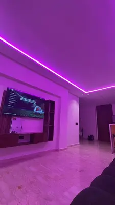 a living room with purple lighting and a tv at Adam résidence in Casablanca