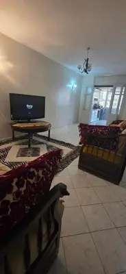 a living room with a tv and a couch and a table at Residence West Duplex in Casablanca