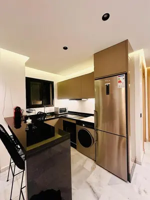 a kitchen with a stainless steel refrigerator and counters at Cozy Studio Steps from Med V Stadium in Casablanca