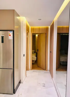 a hallway with a refrigerator in a room at Cozy Studio Steps from Med V Stadium in Casablanca