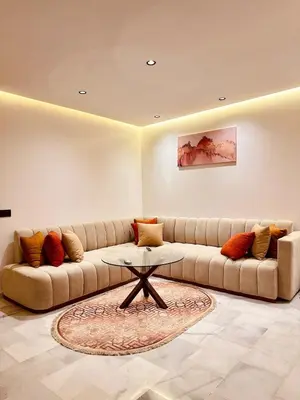 a living room with a couch and a table at Cozy Studio Steps from Med V Stadium in Casablanca
