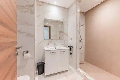 a white bathroom with a sink and a shower at L'Horizon - 1 BR - Pool & Terrace in Nouaseur