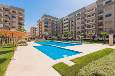 an image of a swimming pool in front of a building at L'Horizon - 1 BR - Pool & Terrace in Nouaseur