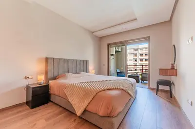 a bedroom with a large bed and a window at L'Horizon - 1 BR - Pool & Terrace in Nouaseur