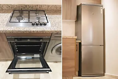 a stainless steel refrigerator in a kitchen next to a stove at Modern apartment with pool parking in O Ben Slimane