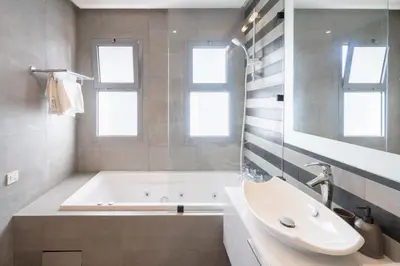 a bathroom with a tub and a sink at Marina Vacation Homes in Casablanca
