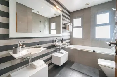 a bathroom with two sinks and a tub at Marina Vacation Homes in Casablanca