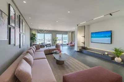 a living room with a large couch and a tv at Marina Vacation Homes in Casablanca