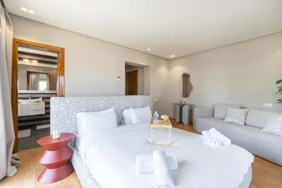a bedroom with a large white bed and a couch at Marina Vacation Homes in Casablanca