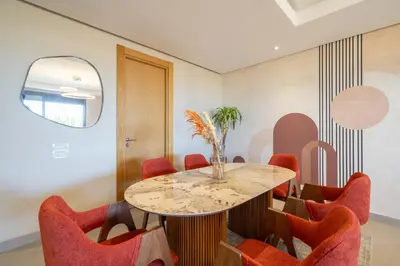 a dining room with a table and red chairs at Marina Vacation Homes in Casablanca