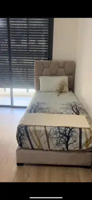 a bed in a bedroom with at Appartement Èlégant Vue piscine in Casablanca