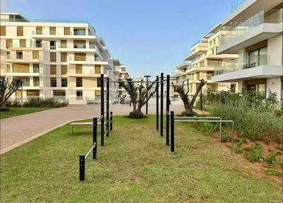 a group of poles in the grass in front of a building at escapade de luxe face a la mer in Rabat