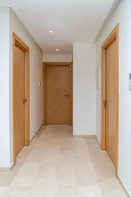 an empty hallway with two doors and a tile floor at escapade de luxe face a la mer in Rabat