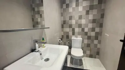 a bathroom with a white toilet and a sink at Between sea and historic center in Rabat