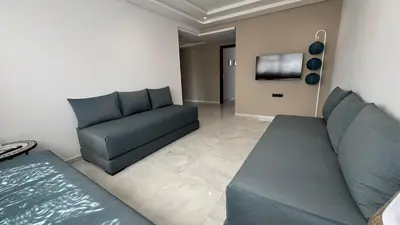 a living room with a couch and a tv at Between sea and historic center in Rabat