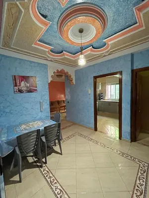 a room with a table and chairs and a ceiling at Cozy apartment in Skhirat near Rabat in Skhirat