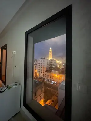a window in a room with a view of a city at Solstice 73 Luffy Air Studio in Casablanca