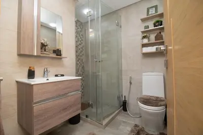 a bathroom with a shower and a toilet and a sink at Studio élégant et neuf près de la gare tgv in Casablanca