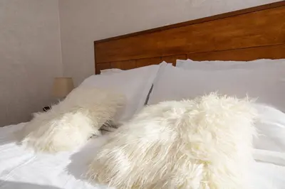 two white furry pillows laying on a bed at Studio élégant et neuf près de la gare tgv in Casablanca