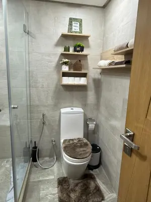 a bathroom with a toilet and a glass shower at Studio élégant et neuf près de la gare tgv in Casablanca