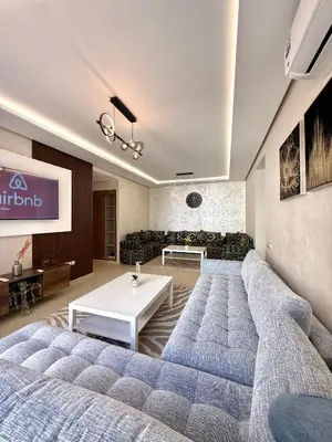 a living room with a couch and a table at N22 Élégance et Confort à La Corniche Rabat - Appartement de Luxe Essabah in Rabat