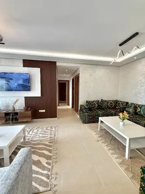 a living room with a couch and a table at N22 Élégance et Confort à La Corniche Rabat - Appartement de Luxe Essabah in Rabat