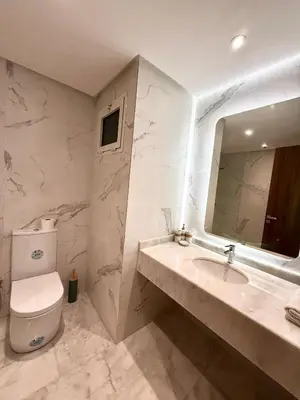 a bathroom with a toilet and a sink and a mirror at N22 Élégance et Confort à La Corniche Rabat - Appartement de Luxe Essabah in Rabat