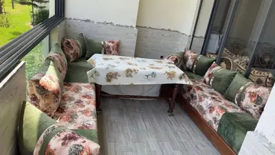 a room with a couch and a table on a balcony at Appartement tamaris les crêtes in Casablanca
