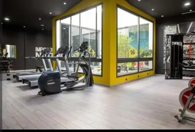 a gym with treadmills and ellipticals in a building at Appartement tamaris les crêtes in Casablanca