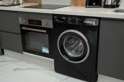 a washing machine in a kitchen with a counter at Mansouria 1BR Pool View Beach Parking in Mansouria
