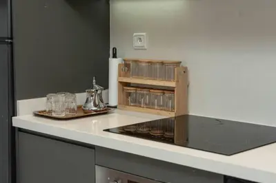 a kitchen with a counter with glasses on it at Mansouria 1BR Pool View Beach Parking in Mansouria