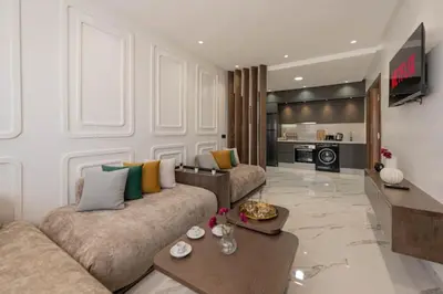 a living room with a couch and a table at Mansouria 1BR Pool View Beach Parking in Mansouria