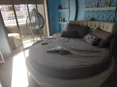 a circular bed in a room with a window at Mansbay Beach Dalia in Mohammedia