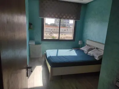 a bedroom with a bed and a window at Mansbay Beach Dalia in Mohammedia