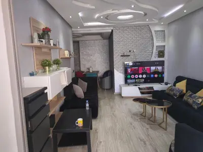 a living room with a couch and a table at Mansbay Beach Dalia in Mohammedia