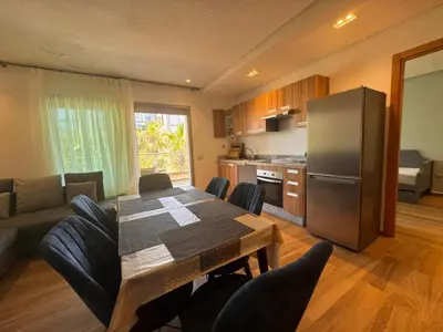 a kitchen and living room with a table and a refrigerator at Blue Beach in Casablanca