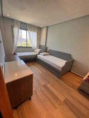a bedroom with a bed and a large window at Blue Beach in Casablanca