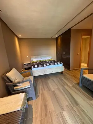 a room with a bed and two couches in it at Blue Beach in Casablanca