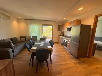 a kitchen and living room with a table and a refrigerator at Blue Beach in Casablanca