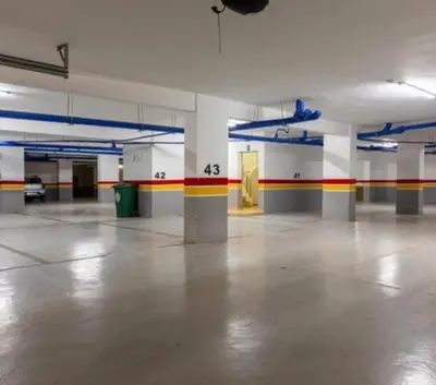 an empty parking garage with a room with colorful walls at Elegance Pool View Apartment in Dar Bouazza