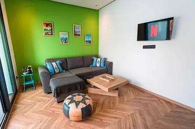 a living room with a couch and a table at Graffiti Chill Zone - Calme en plein Centre in Casablanca