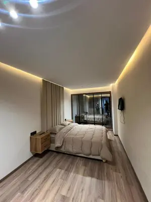 a bedroom with a large bed and a large mirror at studio in Maarif