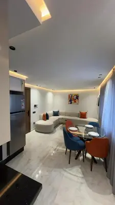 a living room with a couch and a table and chairs at studio in Maarif