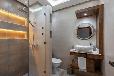 a bathroom with a sink and a toilet and a mirror at Harhoura Luxury Stay, Steps from the Beach in Temara