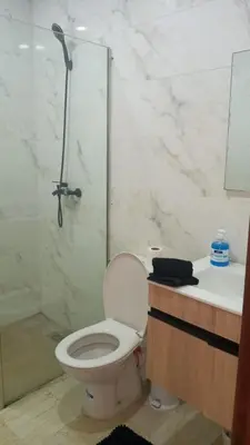 a bathroom with a toilet and a shower and a sink at Casa Comfort Apartment in Casablanca