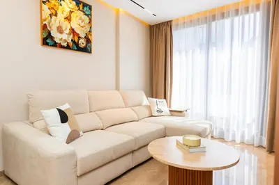 a living room with a white couch and a table at Cozy and new apartment in Princesses in Casablanca