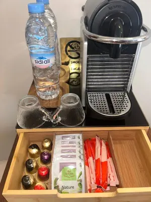 a wooden drawer with a bottle of water and some food at Cozy and new apartment in Princesses in Casablanca