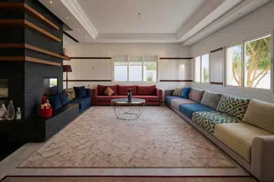 a living room with a couch and a table at Villa piscine in Temara